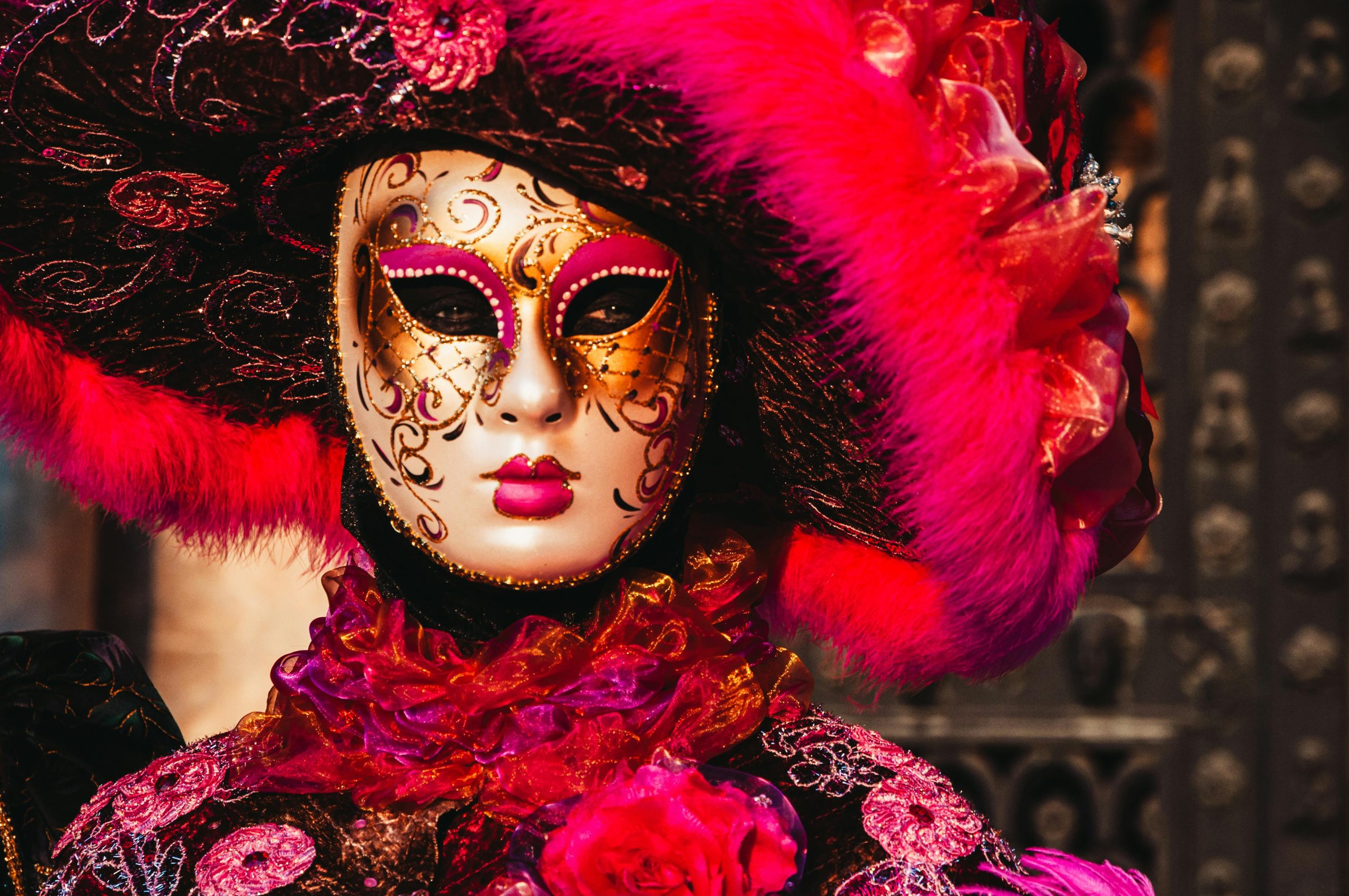 Vibrant Venetian mask and costume at a masquerade, capturing the essence of Venice's Carnival.